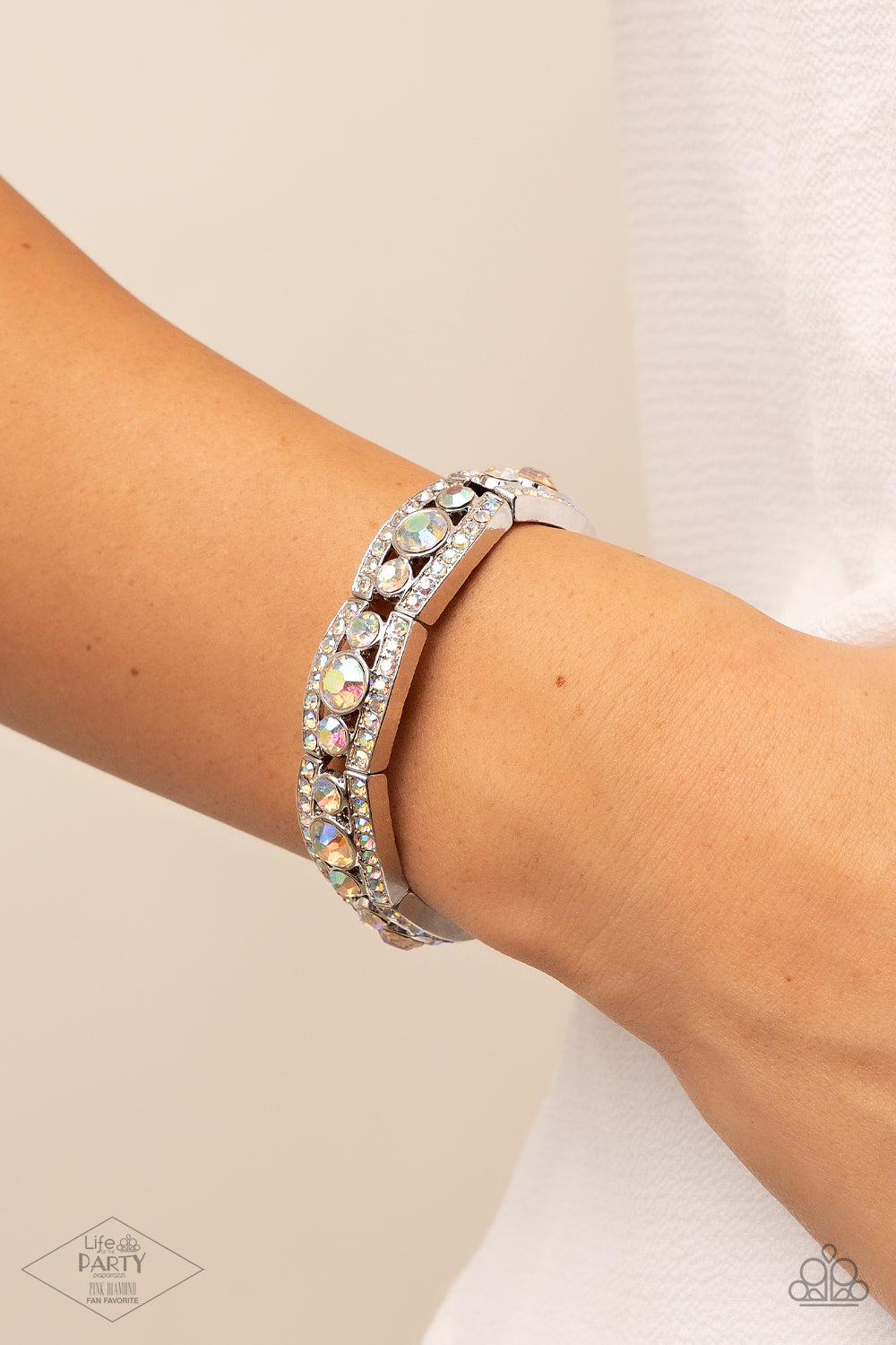 Iridescent rhinestone encrusted silver bars flank a dazzling trio of oversized iridescent rhinestones