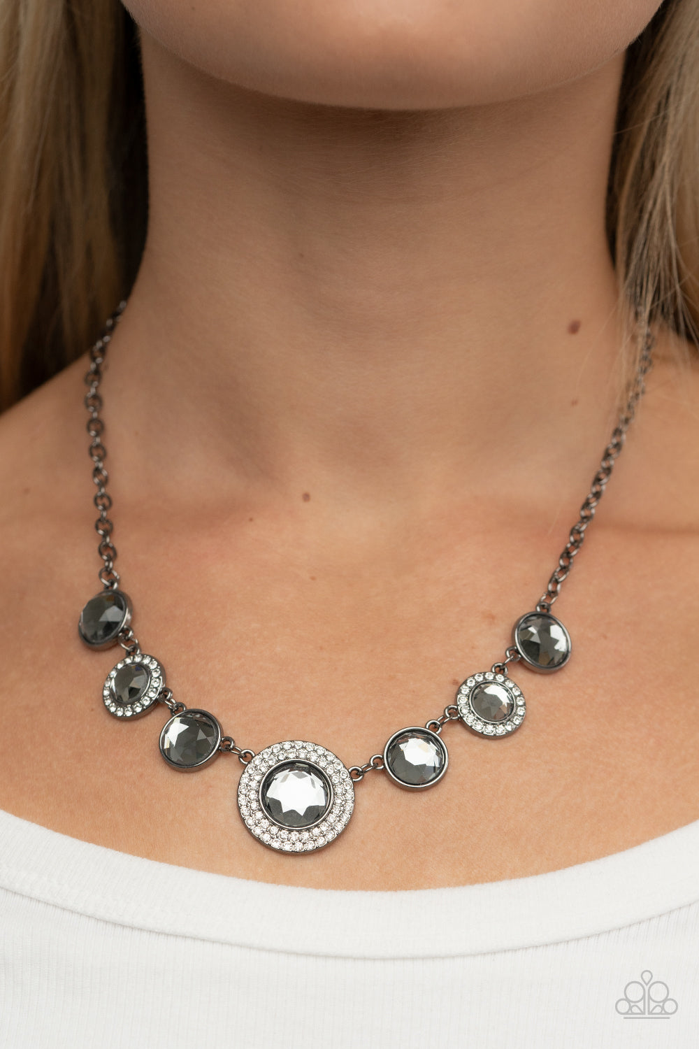 Oversized smoky gems alternate with matching gems bordered in rings of glassy white rhinestones