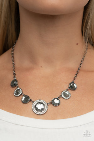 Oversized smoky gems alternate with matching gems bordered in rings of glassy white rhinestones