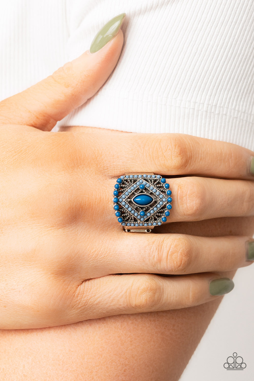 Dainty Spring Lake and Mykonos Blue beads adorn the front of an airy silver frame radiating with studded geometric texture