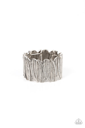 Embossed in feather-like details, pairs of overlapping silver leaf frames are threaded along stretchy bands around the wrist