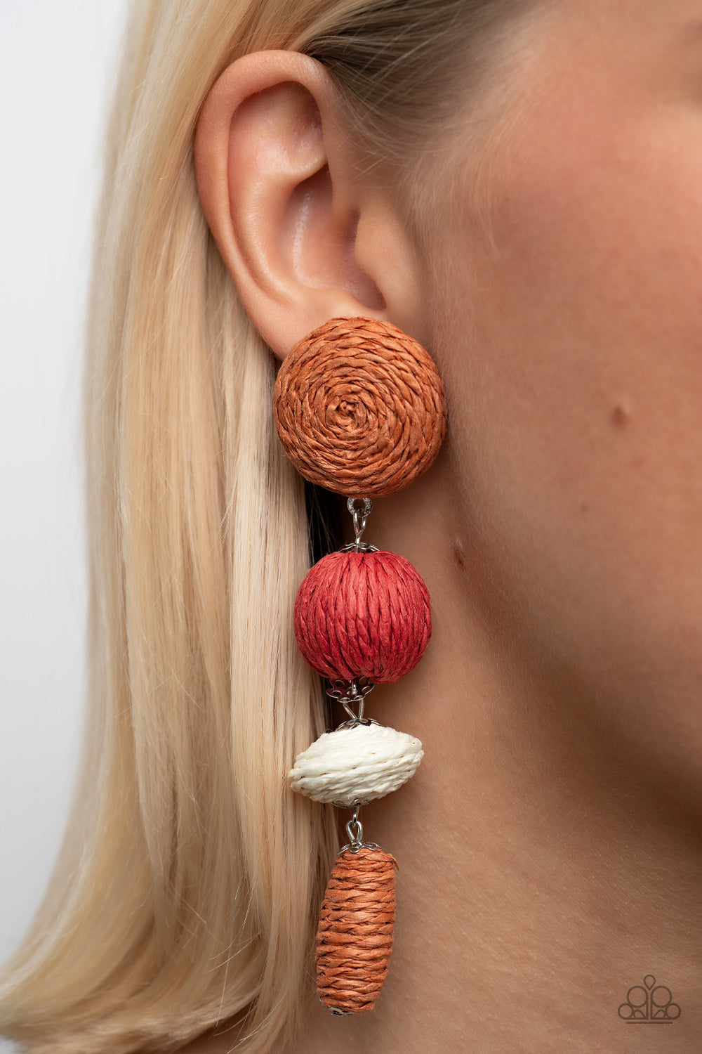 Strands of Adobe, red, white crepe-like twine wraps around circle, sphere, oval, and oblong frames that delicately connect into a decorative tassel 