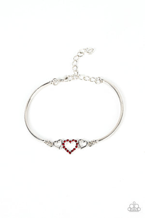 Two shiny silver hearts flank a red rhinestone dotted heart at the center of two curved silver bars, linking into a flirtatious centerpiece around the wrist