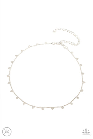 Dainty silver hearts dance from a dainty silver chain around the neck, creating a flirtatious fringe