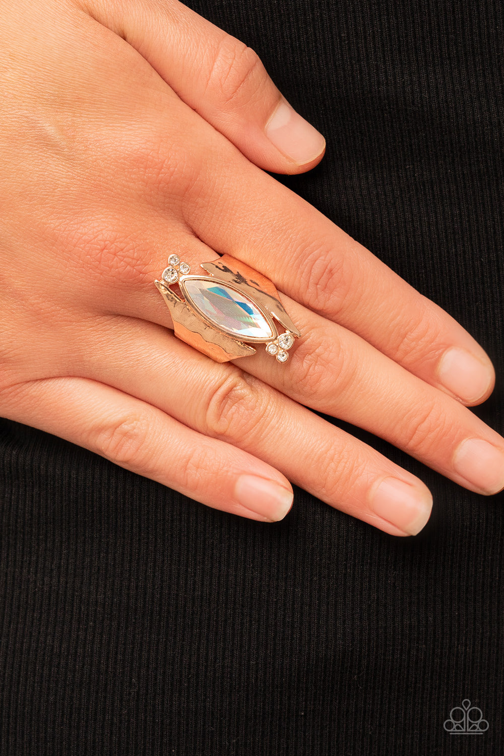 iridescent gem asymmetrically balances between two flared and hammered rose gold frames
