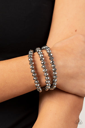Rows of hematite crystal-like beads are threaded along invisible wires around the wrist