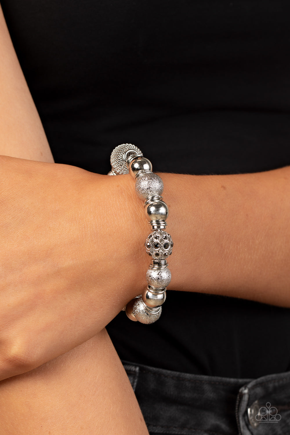 oversized collection of shimmery silver beads, silver rings, hematite rhinestone dotted accents, and wire mesh beads are threaded along stretchy bands