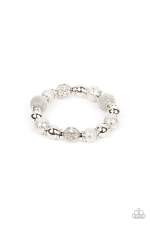 An oversized collection of shimmery silver beads, silver rings, white rhinestone dotted accents, and wire mesh beads are threaded along stretchy bands around the wrist