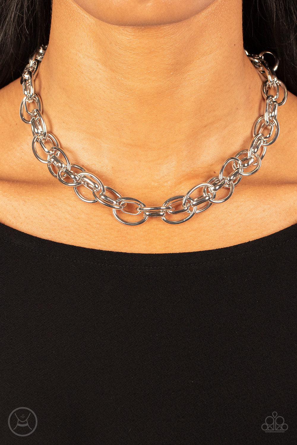 oversized silver chain interlocks with an oval linked chain