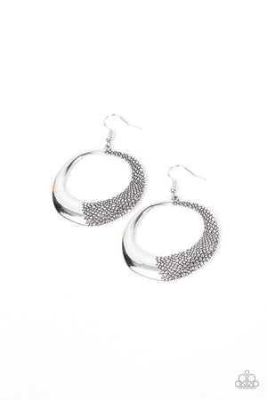 asymmetrical silver hoop is embossed in rugged pebble like texture