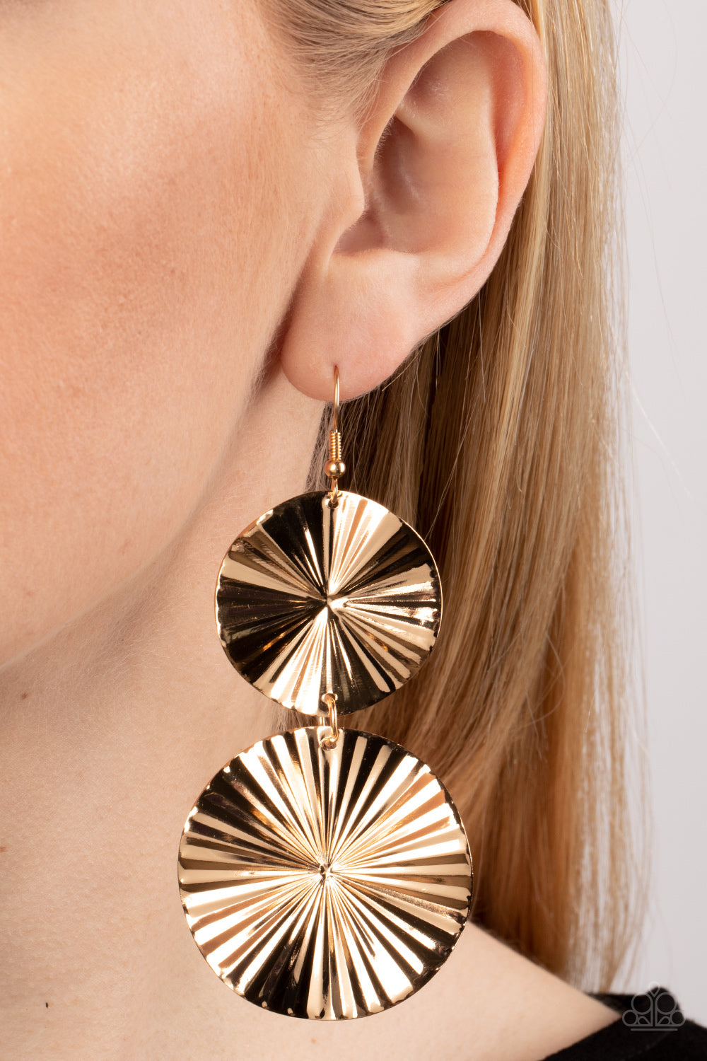 Crinkled with texture, folded gold discs radiate as they delicately link into a tactile lure