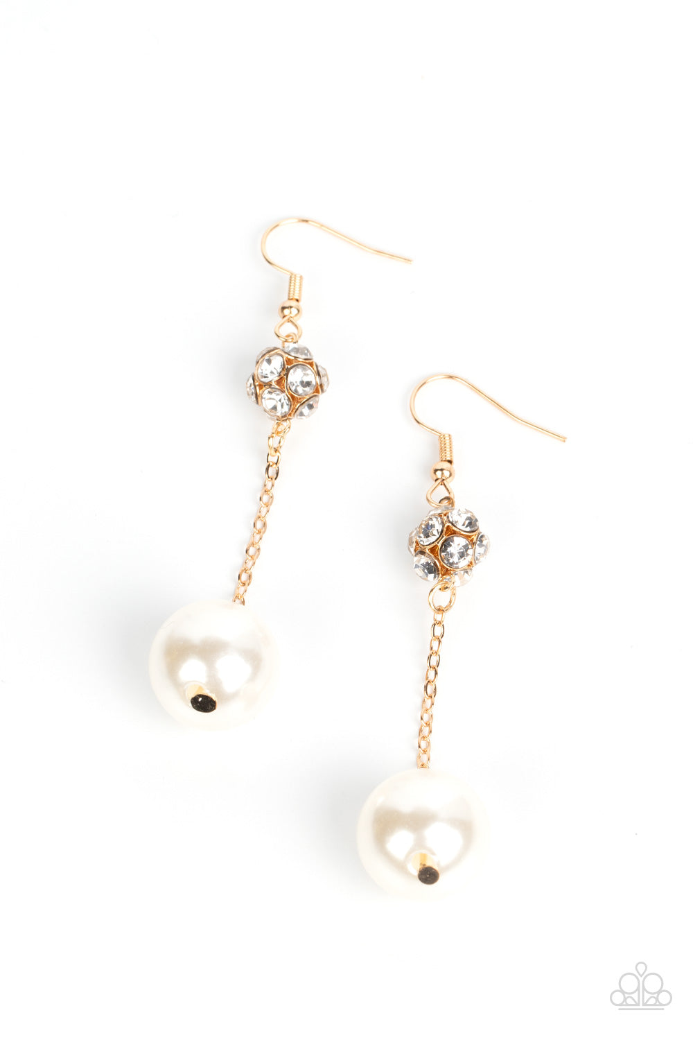 oversized white pearl swings from the bottom of a dainty gold chain that is suspended from a white rhinestone encrusted gold bead