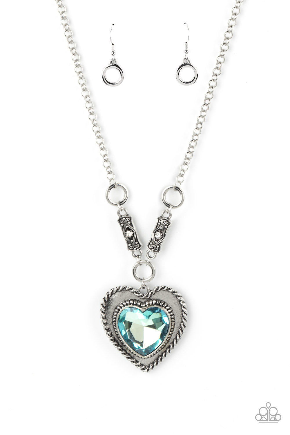 oversized blue heart gem is pressed into a silver heart frame 