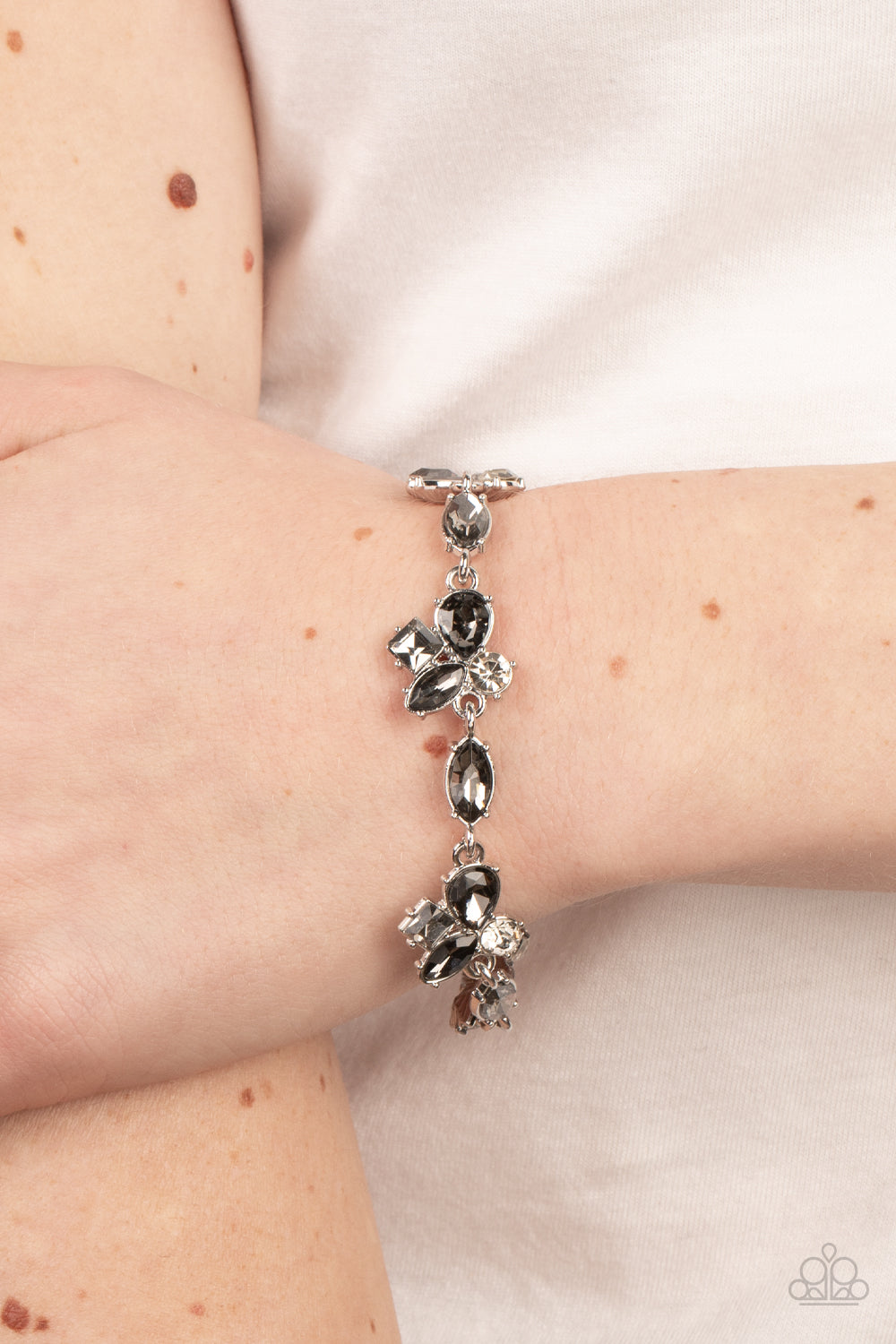 white rhinestones join with a smoky array of teardrop, marquise, and square cut rhinestones