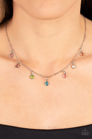  a dainty collection of glassy multicolored gems twinkles along a dainty silver chain