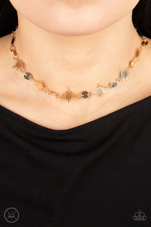 Dainty gold discs delicately alternate with starry gold sunbursts