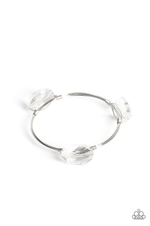 glassy shimmer, oversized faceted gems are wrapped in place along the front of coiled silver wires that join into a solitaire bangle around the wrist