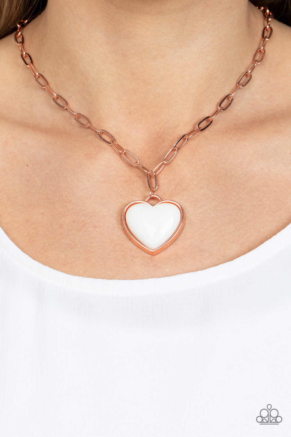 charming heart, a quartz-like gemstone is pressed into the center of a shiny copper fitting at the bottom of a shiny copper chain 