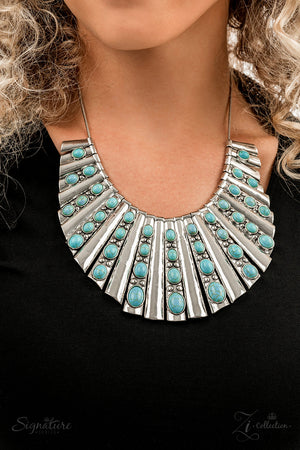 Elongated silver plates featuring a high sheen finish fan out unapologetically along the collar, graduating in size as they lead down to the center. Oval-shaped turquoise stones,
