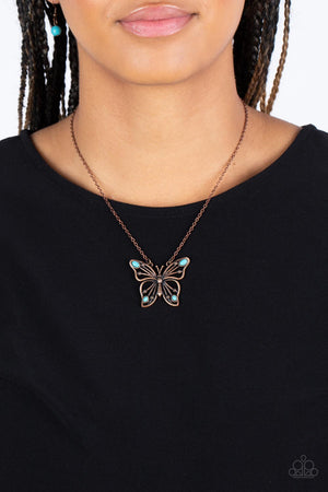 oval turquoise stones, a decorative copper butterfly flutters at the bottom of a copper chain