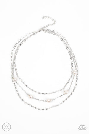 Infused with two oval-linked silver chains, imperfect white pearls adorn a dainty silver chain around the neck