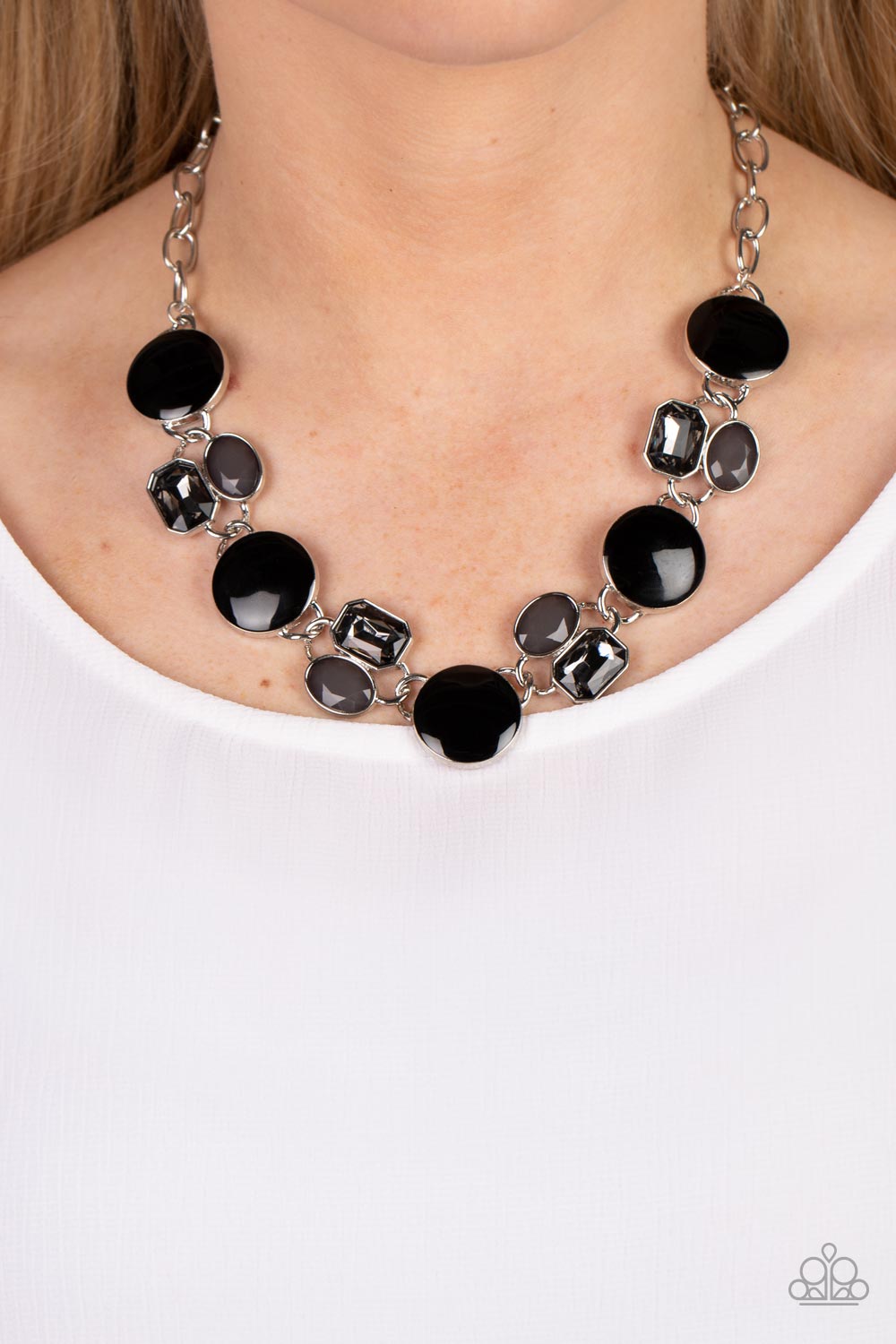 Sparkling smoky gems combine with black beads and alternate across the collar with oversized discs painted in black enamel