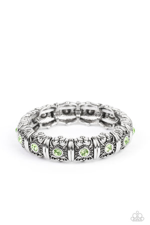 green rhinestones glimmer on threaded stretchy bands around the wrist 