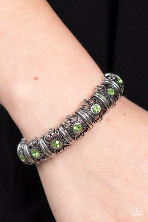 green rhinestones glimmer on threaded stretchy bands around the wrist 