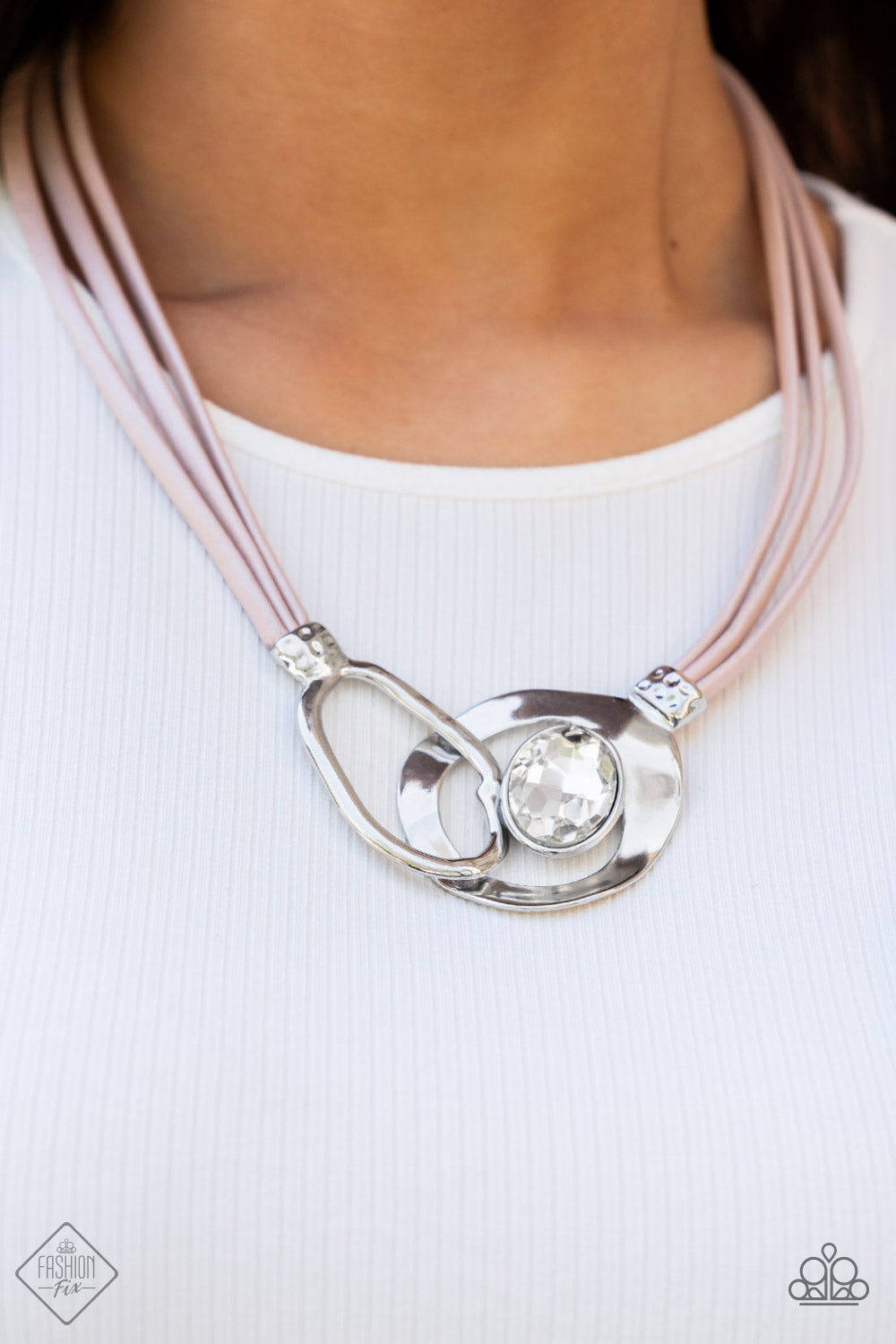 shimmery strands of pink leather, a pair of oversized and warped silver links delicately overlaps into a contemporary centerpiece