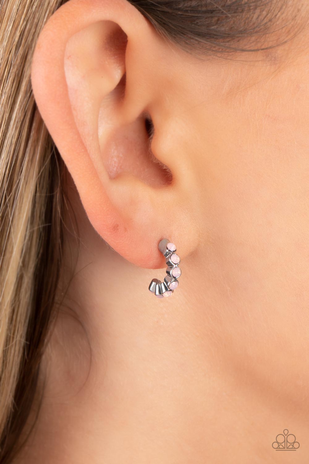 Tiny, rose water, opalescent beads are encased in silver fittings, falling in line as they curve into a dainty hoop